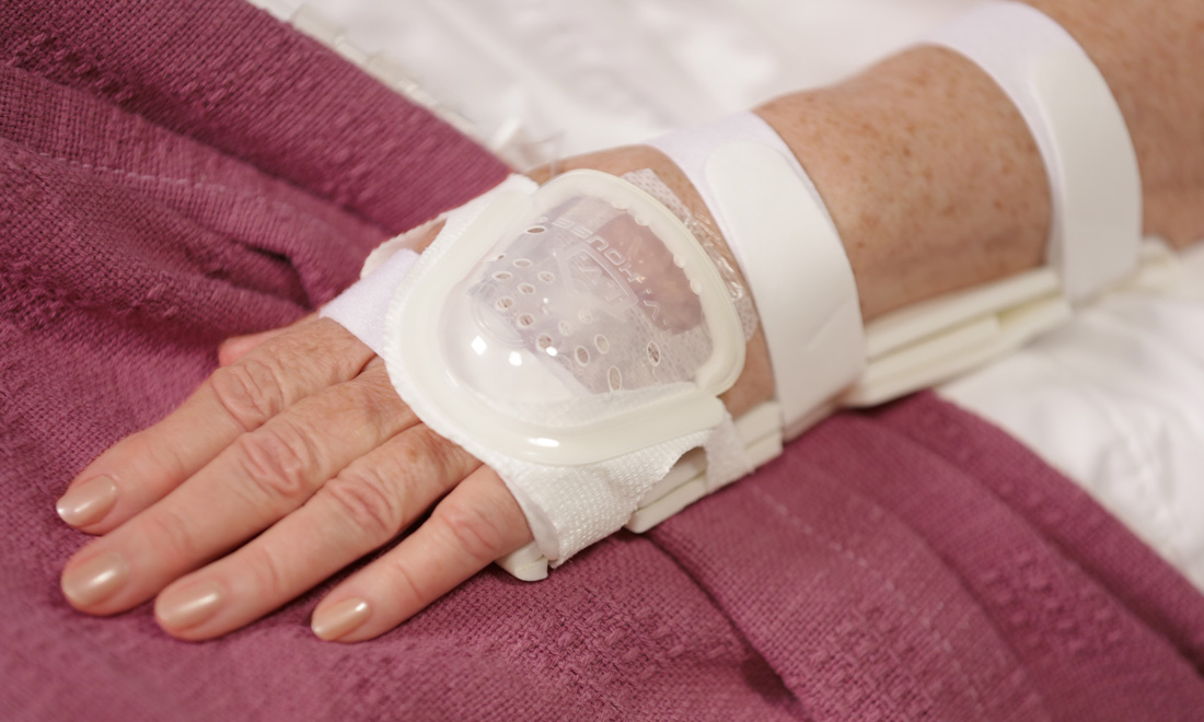 Adult hospital patient with IV protected by I.V. House UltraDome and TLC Splint
